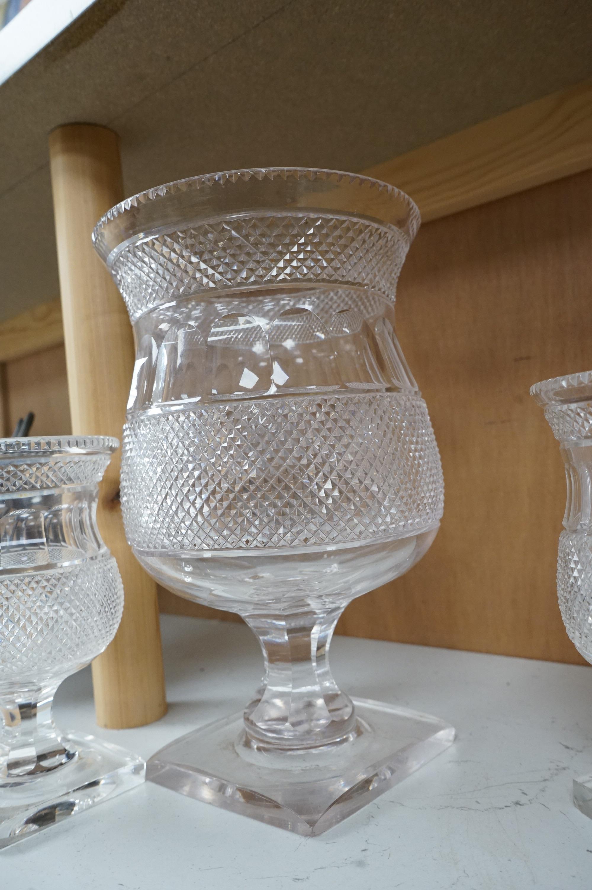A garniture of three 19th century cut glass vases, largest 26cm high